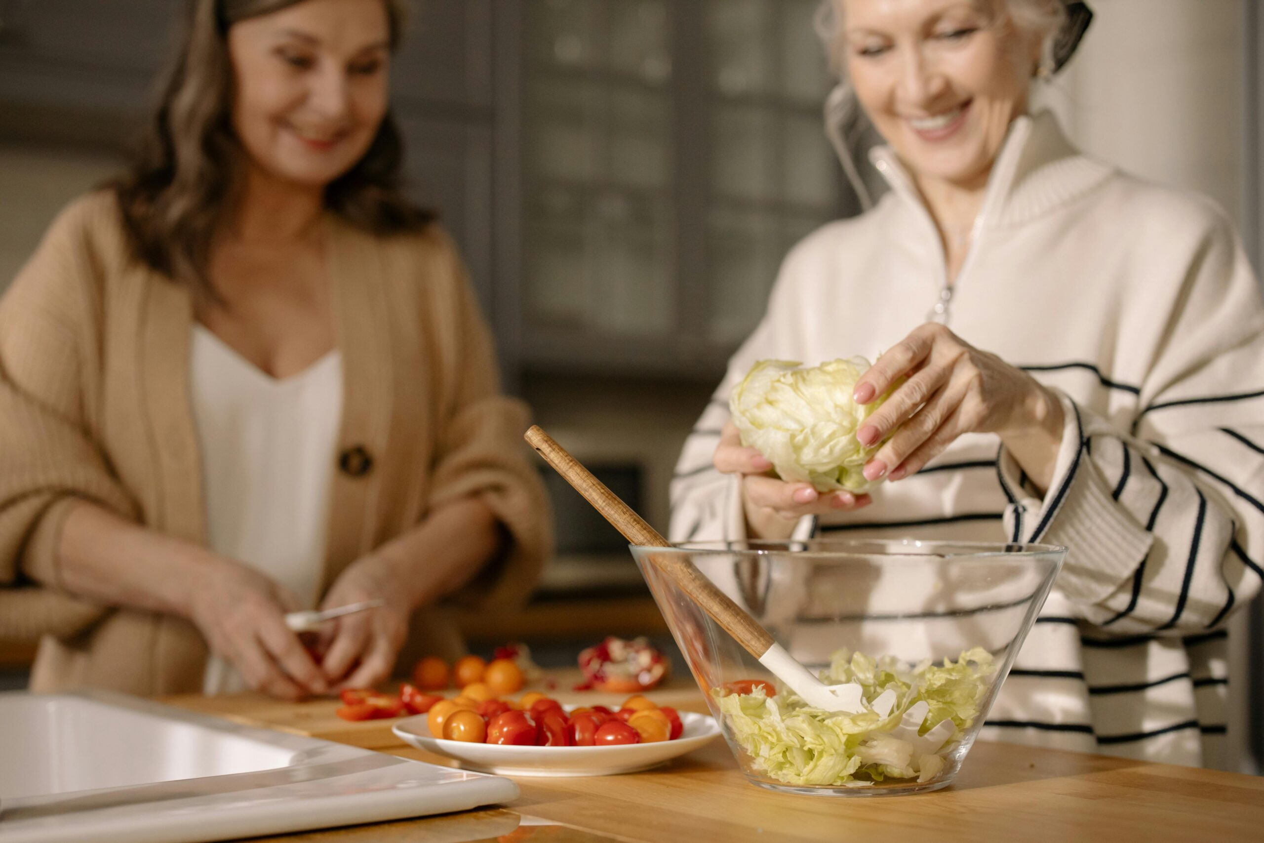 two women making salad