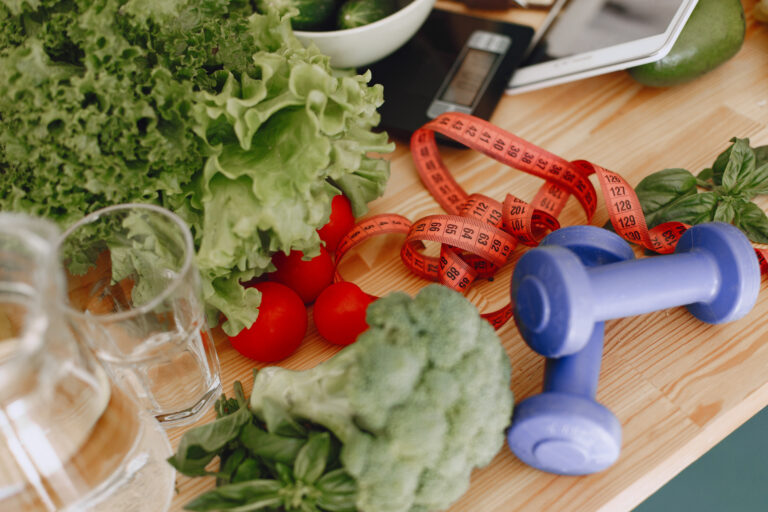 scales tape measure dumbbells and vegetables