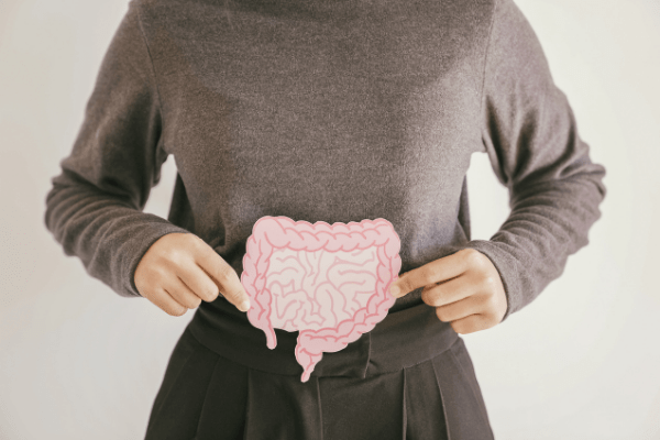 lady holding gut picture over stomach
